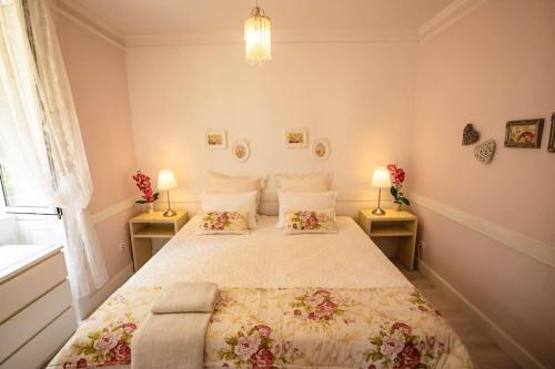 a bedroom with a large bed with two lamps at Private Pool Apt. with Great View in Funchal