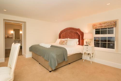 a bedroom with a large bed and a window at Springkell in Eaglesfield