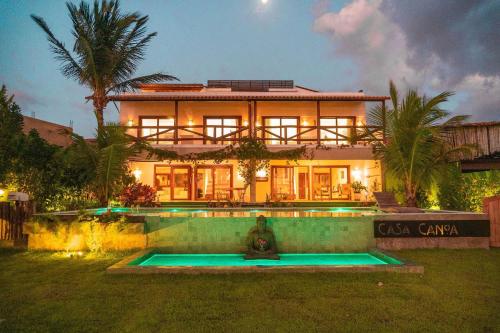 a house with a fire hydrant in front of it at Casa Canoa Camocim in Camocim