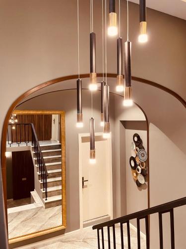 a hallway with a large mirror and a staircase at Eleven Hotel Baku in Baku
