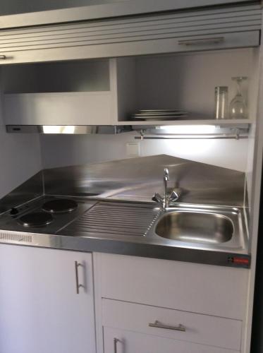 a kitchen with a sink and a stove at Sailinn Mykonos in Ornos