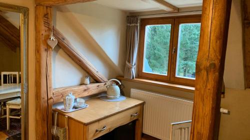 a room with a wooden table and a window at Krasná Samota in Chřibská