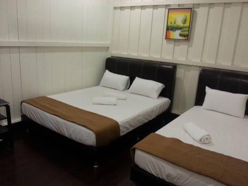 En eller flere senge i et værelse på Green Season Cottage