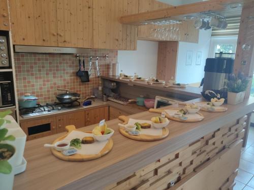 a kitchen counter with several plates of food on it at 墾丁后灣仙杜瑞拉海景旅宿 in Checheng