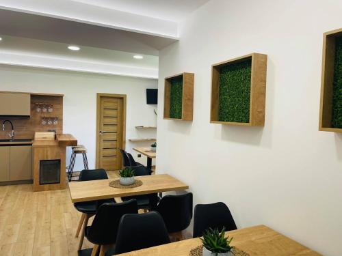 a kitchen and dining room with tables and chairs at Penzion Pod Kaštanem in Nedakonitz