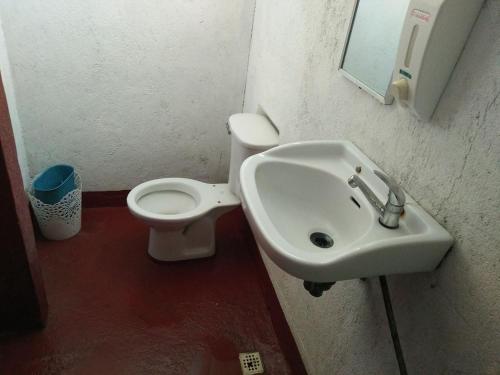 a bathroom with a sink and a toilet at Hideaway Resort in Maraat