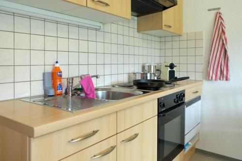 a kitchen with a sink and a stove at Luna in Thun