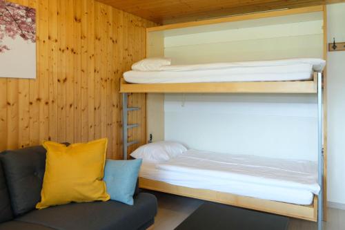 a bunk bed and a couch in a room at Luna in Thun