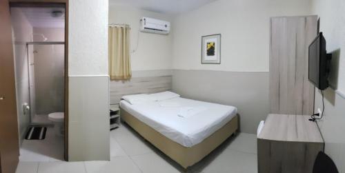 Cama ou camas em um quarto em Hotel Uzi Praia