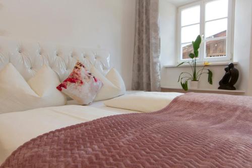 a bedroom with a white bed and a window at Gasthof zur Post in Mieming