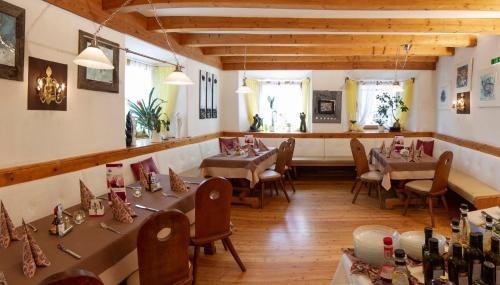 a restaurant with tables and chairs in a room at Gasthof zur Post in Mieming