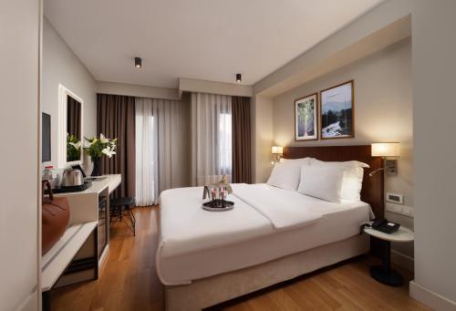 a hotel room with a large bed and a desk at Suadhan Hotel in Istanbul