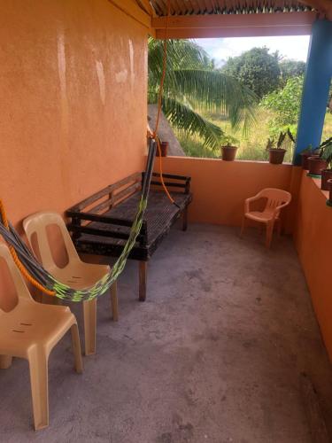a room with a hammock and two chairs and a window at Hideaway Resort Victoria secret hideaway resort in Maraat