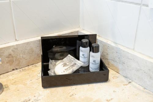 a box with bottles ofodorizers sitting on the floor at H4 La Residence Paulista in Sao Paulo