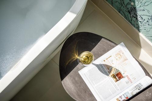 a cd and a newspaper on a table next to a door at Barnett Hill Hotel in Guildford