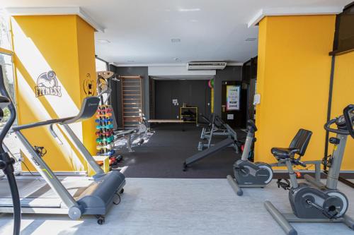 a gym with several treadmills and exercise bikes at H4 La Residence Paulista in Sao Paulo