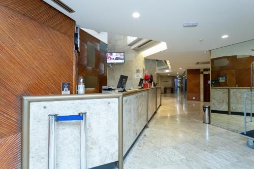 a lobby of a hospital with a reception counter at H4 La Residence Paulista in Sao Paulo