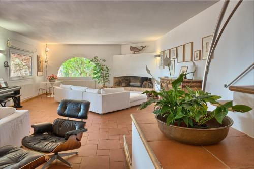 a living room with a couch and a fireplace at Sa Tuna Villa CEMA in Begur