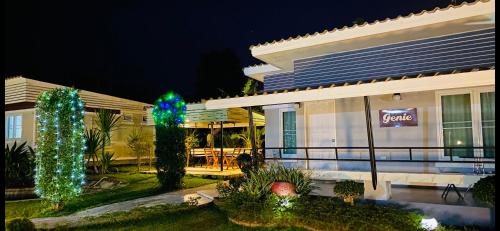 a building with christmas lights in front of it at Panutsaya Homestay in Wang Nam Khieo
