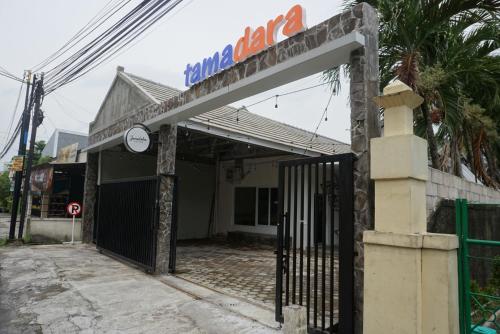 an entrance to a building with a gate at Tamadara Guesthouse Jogja in Seturan