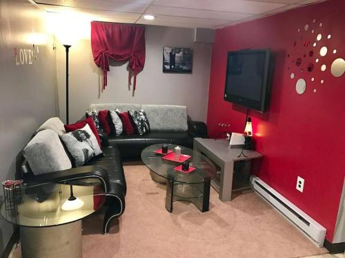 a living room with a couch and a tv at Beautiful Chalet with Hot Tub & Sauna in Poconos in Long Pond