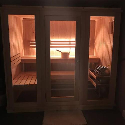 a cabinet with two glass doors in a room at Beautiful Chalet with Hot Tub & Sauna in Poconos in Long Pond