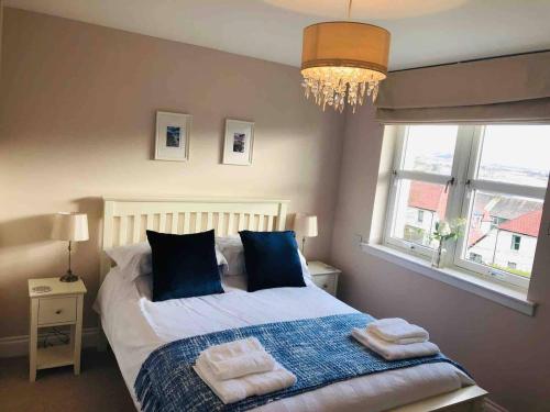 a bedroom with a bed with towels on it at Two bedroom house in central Portree in Portree