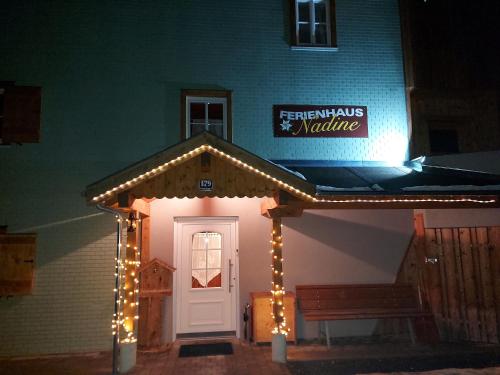 a building with a white door with lights around it at Ferienhaus Nadine in Kappl