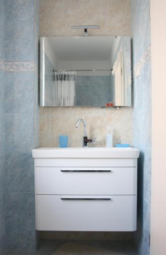 a bathroom with a white sink and a mirror at Luxury Villa Roza in Split