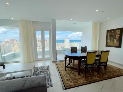 a dining room with a table and chairs in a living room at Sea View Paradise in Alexandria
