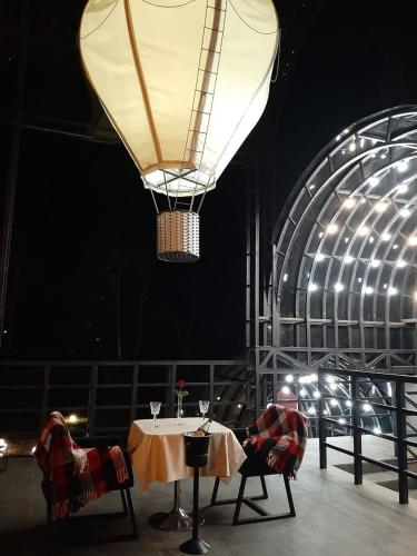 a room with a table and a large light at Hotel Zefir in Drohobytsch