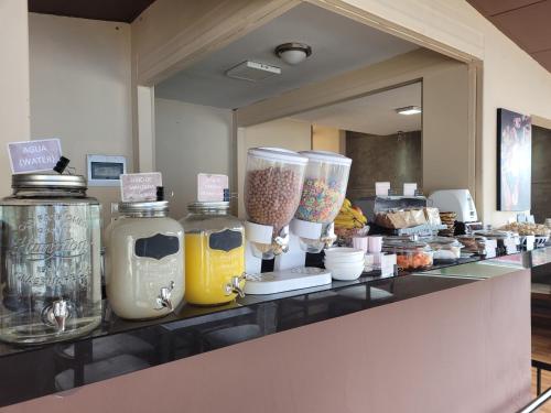 a counter with some jars of food on it at Hotel Monte Carlo in La Paz