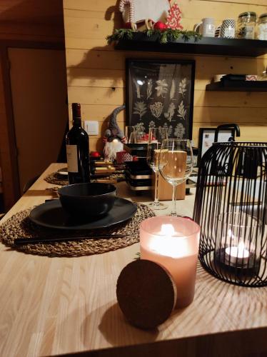 a table with a candle and wine glasses on it at Au Pré de Mukky in Andenne