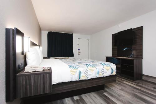 a bedroom with a bed and a phone on a table at Studio 6 Houston TX Medical Center NRG Stadium in Houston
