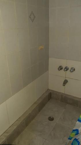 a bathroom with a shower with two faucets on the wall at Calinago Friendly Family Sxm in Philipsburg