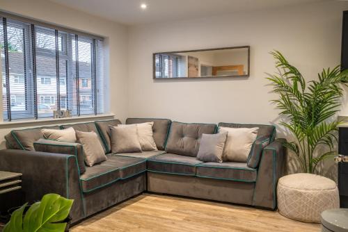 a living room with a couch and a mirror at Mill Road Ground Floor Apartment in Crawley