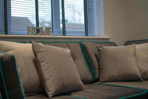 a couch with pillows on it in a living room at Mill Road Ground Floor Apartment in Crawley