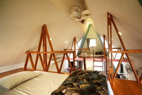 a bedroom with a bed in a room with stairs at Kitefarm in Dongshan