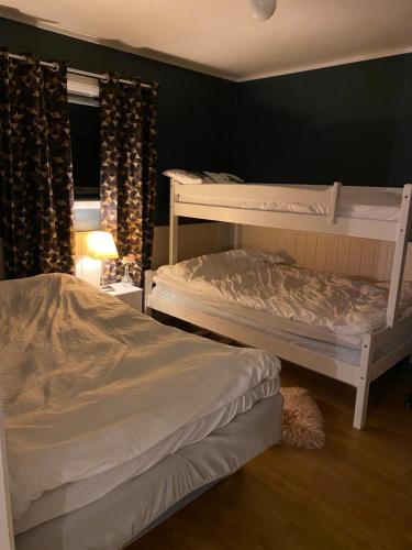 a bedroom with two bunk beds and a window at Lyngen, Mackay appartment, Lyngen in Lyngseidet