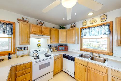a kitchen with wooden cabinets and white appliances at Alelleo's Retreat #13-S in Salvo