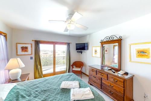 a bedroom with a bed and a dresser and a mirror at Alelleo's Retreat #13-S in Salvo