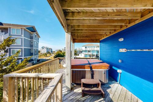a porch with a bed and a chair on a deck at Alelleo's Retreat #13-S in Salvo
