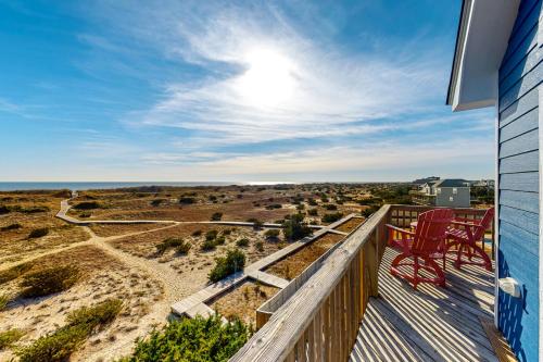 a deck with two red chairs on top of a house at Alelleo's Retreat #13-S in Salvo
