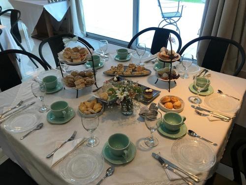 a table with plates and glasses and food on it at Villa Isidro Hotel Boutique & Spa in San Isidro