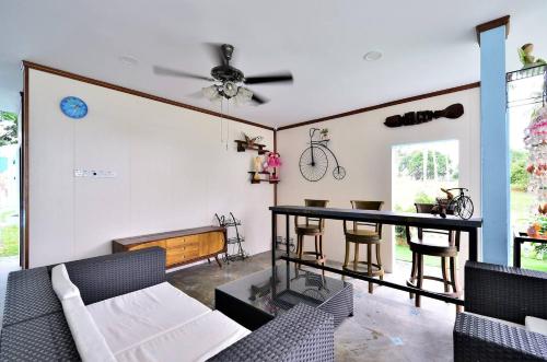 a living room with a couch and a table at Atlantis Dome Villa Lot 3108 in Kampong Alor Gajah