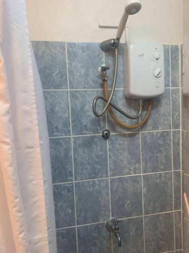 a shower with a blow dryer in a bathroom at Cool Running Apartments in Saint Georgeʼs