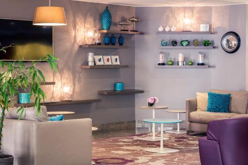 
a living room filled with furniture and decor at Mercure Marseille Centre Vieux Port in Marseille
