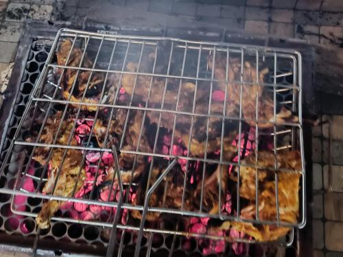 a rack of food cooking on a grill at Nandana's Residency Munnar - A 4BHK Homestay for Indian Families in Munnar