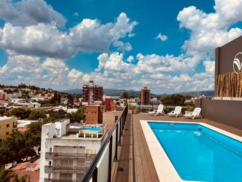 a view from the balcony of a hotel with a swimming pool at Departamento frente al lago en Villa Carlos Paz in Villa Carlos Paz