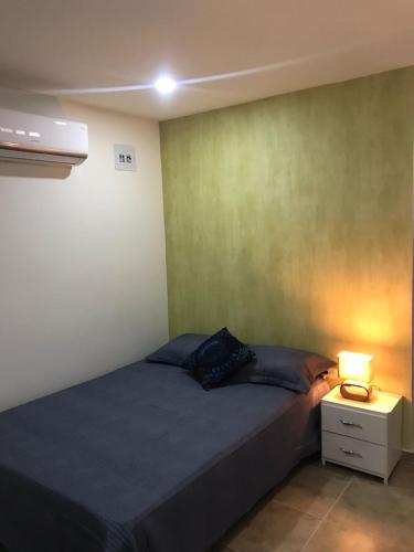 a bedroom with a bed and a lamp on a night stand at Casa Antonella SM in Santa Marta